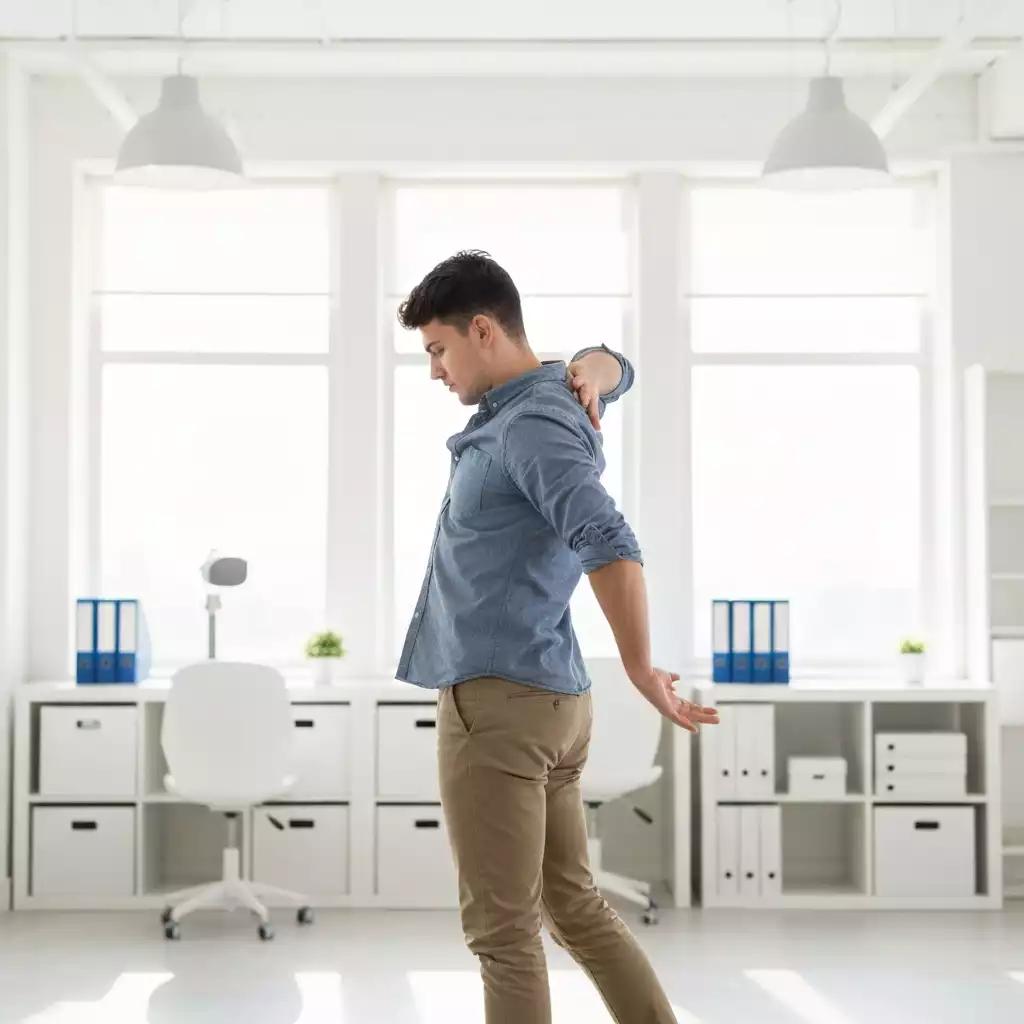 Person performing simple desk stretches to improve flexibility and circulation